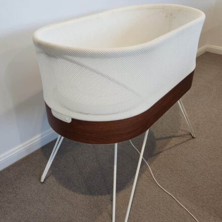 Refurbished Snoo Smart Sleeper on legs in a clean nursery