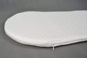 Close-up of Snoo bassinet mattress showing corner zip and textured organic cotton cover.